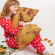 Woman in heart pajamas hugs fried chicken body pillow